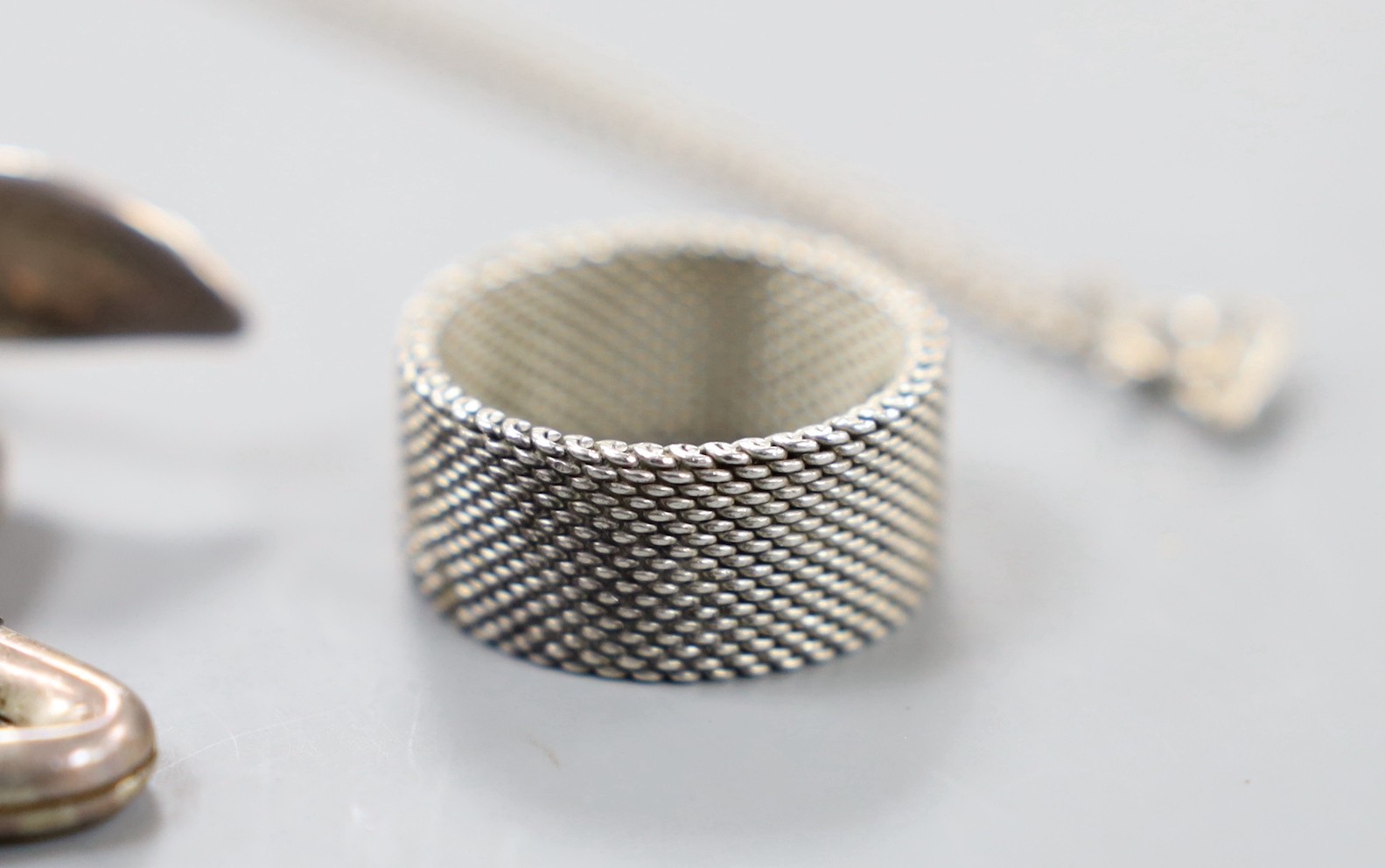 A modern Tiffany & Co. sterling ring, size O/P and a similar pendant and key ring.